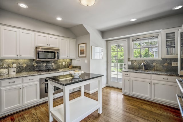 2717 University Blvd, Houston, TX 77005 - kitchen featuring stainless steel appliances, backsplash, white cabinets, and recessed lighting