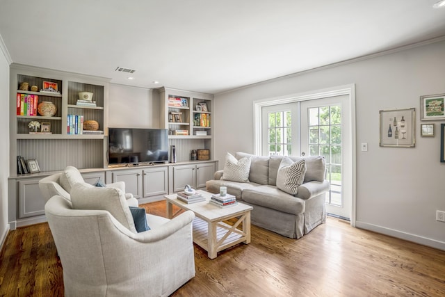 2717 University Blvd, Houston, TX 77005 - living room with crown molding, light wood finished floors, and built in shelves
