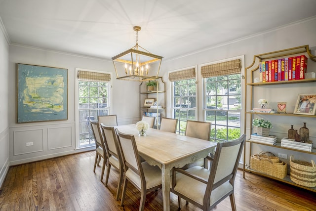 2717 University Blvd, Houston, TX 77005 - dining space with a chandelier, wood-type flooring, ornamental molding, a decorative wall, and wainscoting