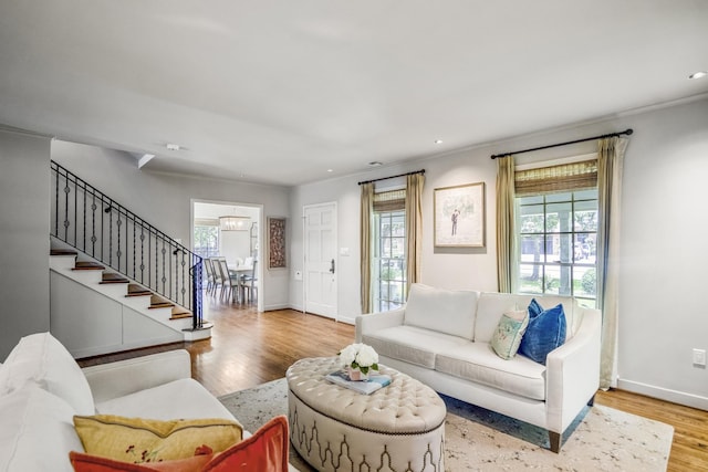 2717 University Blvd, Houston, TX 77005 - living room with stairs, wood finished floors, plenty of natural light, a chandelier, and crown molding