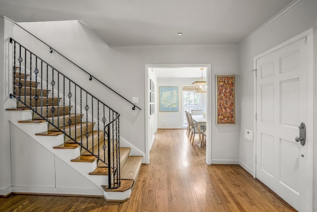 2717 University Blvd, Houston, TX 77005 - foyer featuring wood finished floors, crown molding, a chandelier, and stairs