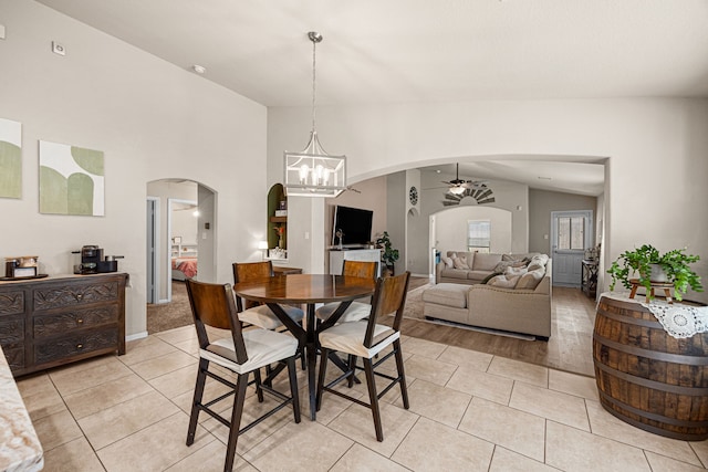 15003 Moonlight Mist Dr, Humble, TX 77346 - dining area with arched walkways, ceiling fan, light tile patterned floors, lofted ceiling, and a chandelier
