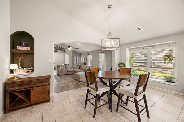 15003 Moonlight Mist Dr, Humble, TX 77346 - dining area with a chandelier, a ceiling fan, light tile patterned floors, arched walkways, and high vaulted ceiling