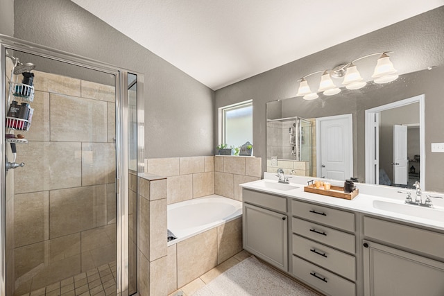 15003 Moonlight Mist Dr, Humble, TX 77346 - full bathroom with a textured wall, a stall shower, a garden tub, double vanity, and lofted ceiling