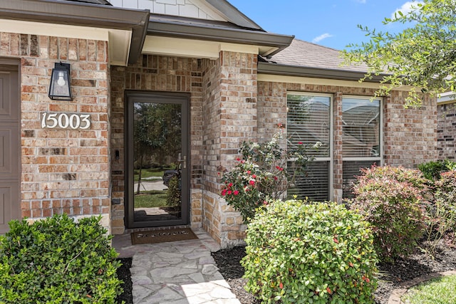 15003 Moonlight Mist Dr, Humble, TX 77346 - property entrance featuring brick siding and roof with shingles