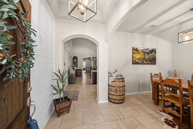 15003 Moonlight Mist Dr, Humble, TX 77346 - entrance foyer with arched walkways, vaulted ceiling, light tile patterned flooring, and a chandelier