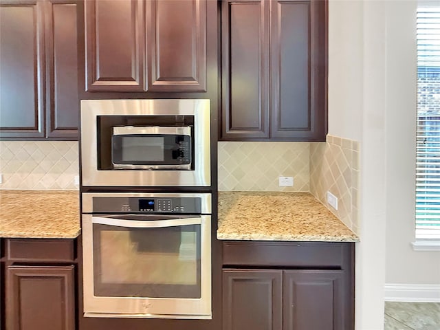 18614 Rimini Ridge Ct, Cypress, TX 77429 - kitchen featuring appliances with stainless steel finishes, decorative backsplash, and light stone counters