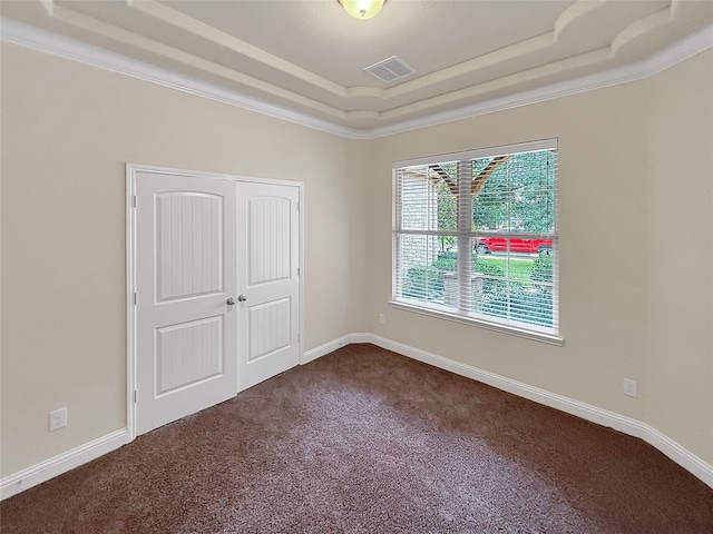18614 Rimini Ridge Ct, Cypress, TX 77429 - unfurnished bedroom with a raised ceiling, dark colored carpet, and a closet