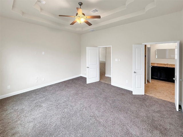18614 Rimini Ridge Ct, Cypress, TX 77429 - unfurnished bedroom with a raised ceiling, carpet, a ceiling fan, and ensuite bathroom