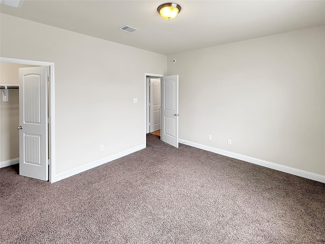 18614 Rimini Ridge Ct, Cypress, TX 77429 - unfurnished bedroom with dark colored carpet and a closet