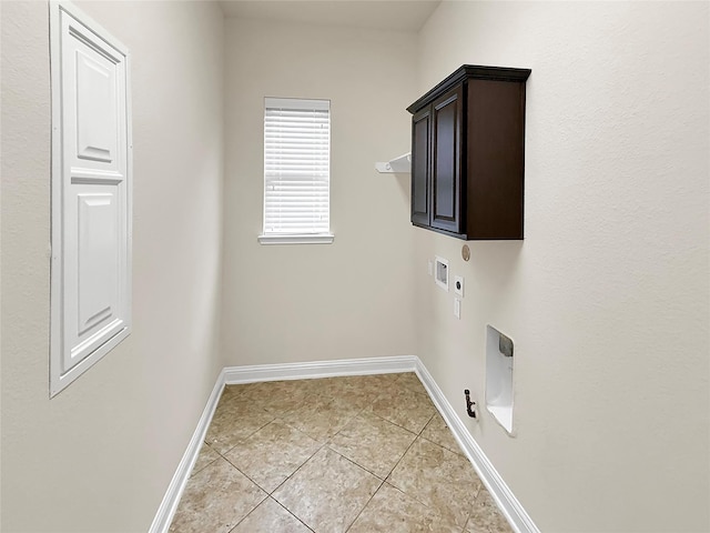 18614 Rimini Ridge Ct, Cypress, TX 77429 - laundry area with hookup for a gas dryer, hookup for an electric dryer, cabinet space, washer hookup, and light tile patterned floors