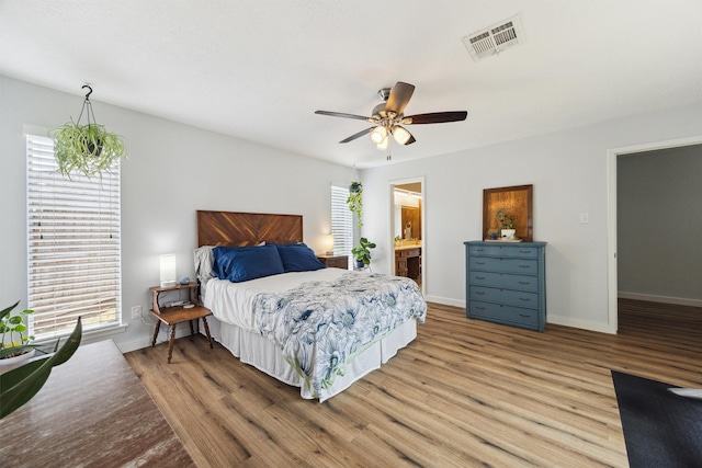 1818 Berryfield Dr, Houston, TX 77077 - bedroom featuring wood finished floors, ceiling fan, and ensuite bath