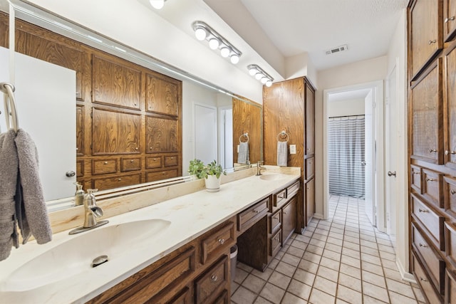 1818 Berryfield Dr, Houston, TX 77077 - bathroom with double vanity and tile patterned flooring