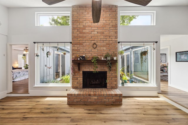1818 Berryfield Dr, Houston, TX 77077 - unfurnished living room with a high ceiling, plenty of natural light, wood finished floors, ceiling fan, and a brick fireplace