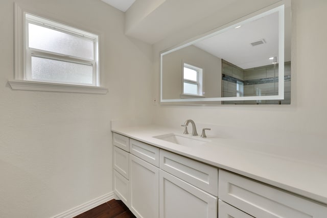 519 N Shady Ln, La Porte, TX 77571 - full bathroom featuring vanity, wood finished floors, and a tile shower