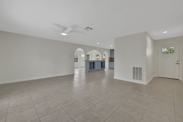 519 N Shady Ln, La Porte, TX 77571 - unfurnished living room with light tile patterned flooring, ceiling fan, recessed lighting, and arched walkways