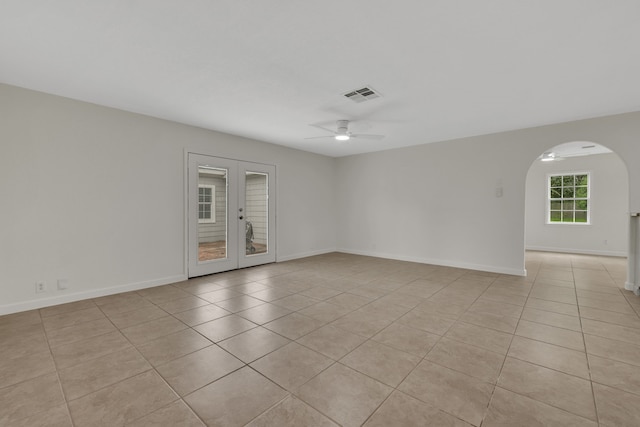519 N Shady Ln, La Porte, TX 77571 - spare room featuring a ceiling fan, light tile patterned floors, french doors, and arched walkways