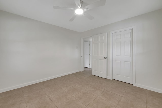 519 N Shady Ln, La Porte, TX 77571 - unfurnished bedroom featuring a ceiling fan and light tile patterned floors