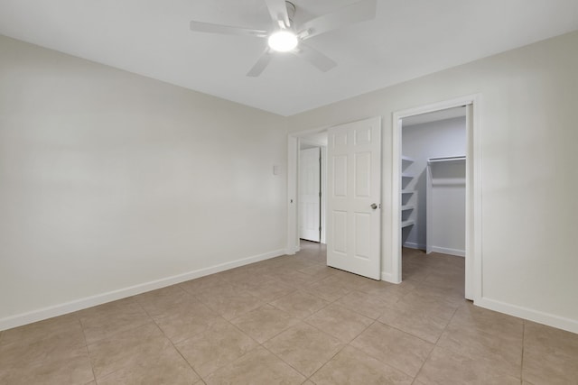519 N Shady Ln, La Porte, TX 77571 - unfurnished bedroom featuring a spacious closet, ceiling fan, and light tile patterned floors