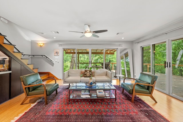 7539 Santa Fe Dr, Houston, TX 77061 - living area featuring wood finished floors, a ceiling fan, stairs, and recessed lighting