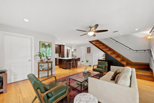 7539 Santa Fe Dr, Houston, TX 77061 - living area featuring stairway, a ceiling fan, light wood-type flooring, and recessed lighting