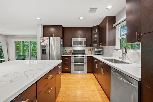 7539 Santa Fe Dr, Houston, TX 77061 - kitchen featuring stainless steel appliances, plenty of natural light, light wood-type flooring, decorative backsplash, and recessed lighting
