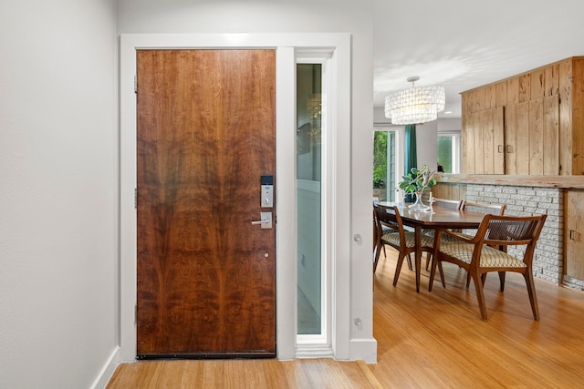 7539 Santa Fe Dr, Houston, TX 77061 - foyer featuring light wood finished floors and a chandelier