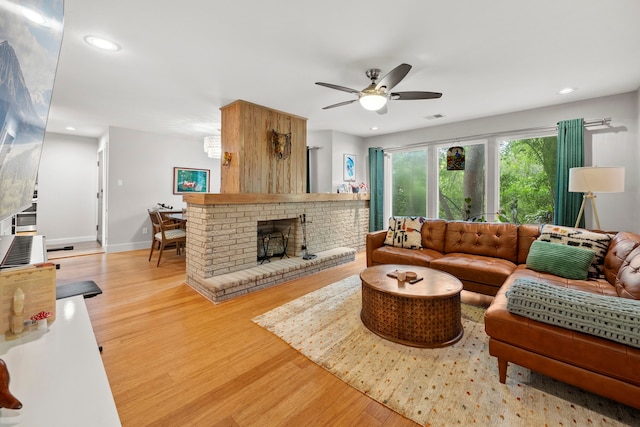 7539 Santa Fe Dr, Houston, TX 77061 - living room with light wood-type flooring, a ceiling fan, recessed lighting, and a fireplace