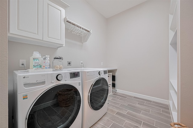 4107 Rainflower Ct, Fulshear, TX 77441 - laundry area with independent washer and dryer, cabinet space, and wood tiled floors