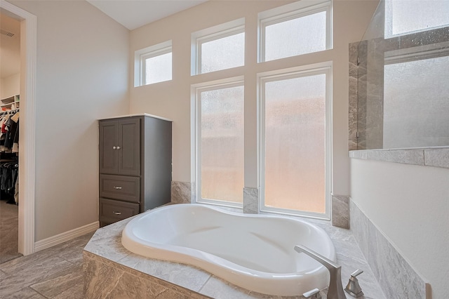 4107 Rainflower Ct, Fulshear, TX 77441 - bathroom with a garden tub and a spacious closet