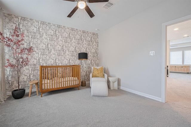 4107 Rainflower Ct, Fulshear, TX 77441 - bedroom with wallpapered walls, carpet floors, a nursery area, ceiling fan, and an accent wall