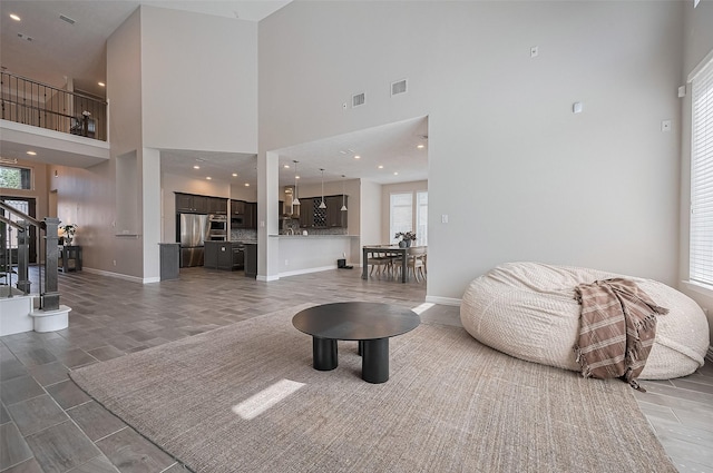 4107 Rainflower Ct, Fulshear, TX 77441 - living room featuring a towering ceiling and stairway