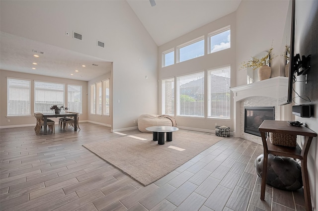 4107 Rainflower Ct, Fulshear, TX 77441 - living room with plenty of natural light, wood finish floors, a tile fireplace, and high vaulted ceiling