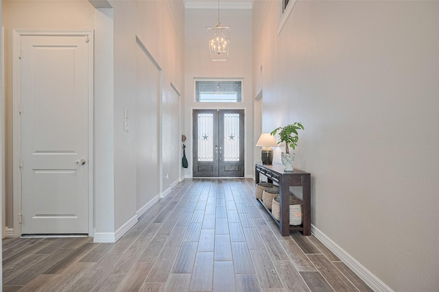4107 Rainflower Ct, Fulshear, TX 77441 - foyer with a chandelier, wood finished floors, a high ceiling, and crown molding