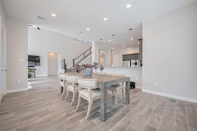 4107 Rainflower Ct, Fulshear, TX 77441 - dining room with stairs, light wood-type flooring, and recessed lighting