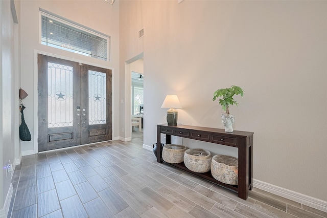 4107 Rainflower Ct, Fulshear, TX 77441 - entryway with wood finish floors, a high ceiling, and french doors