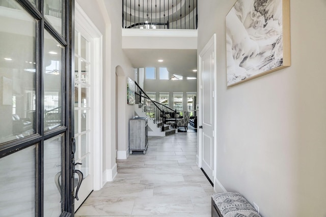 19222 Bullard Creek Dr, Cypress, TX 77433 - hall with stairs, a high ceiling, and light marble finish flooring