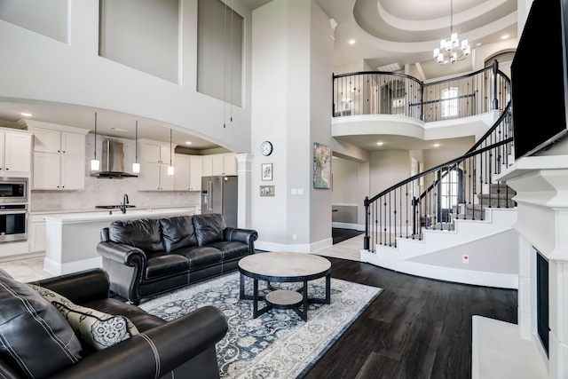 19222 Bullard Creek Dr, Cypress, TX 77433 - living room featuring a high ceiling, wood finished floors, recessed lighting, stairway, and a chandelier