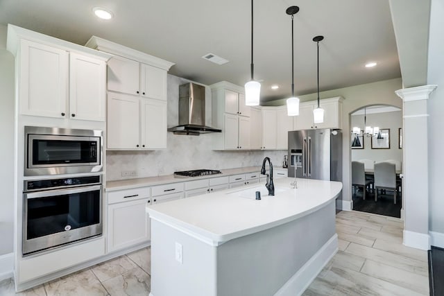 19222 Bullard Creek Dr, Cypress, TX 77433 - kitchen featuring appliances with stainless steel finishes, wall chimney exhaust hood, light marble finish floors, light countertops, and recessed lighting