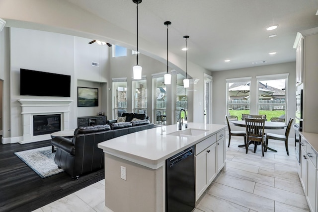 19222 Bullard Creek Dr, Cypress, TX 77433 - kitchen featuring black dishwasher, plenty of natural light, light countertops, a center island with sink, and recessed lighting