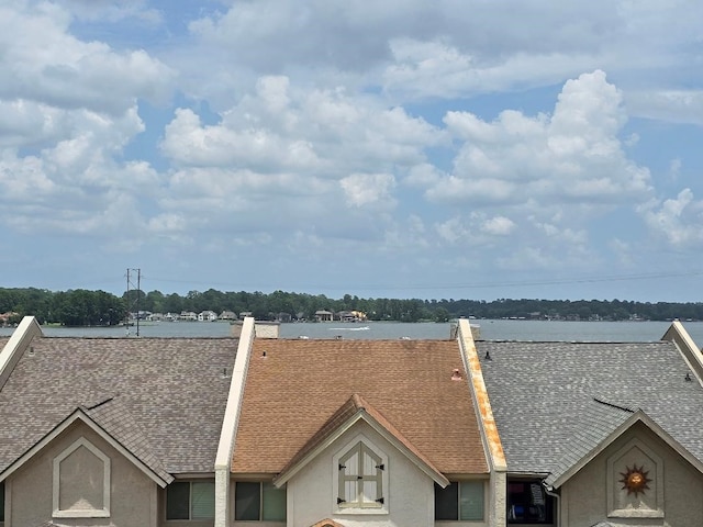 176 Capetown, Conroe, TX 77356 - exterior view of roof with shingles and stucco siding