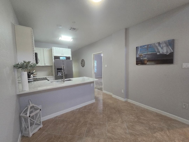 176 Capetown, Conroe, TX 77356 - kitchen featuring a peninsula, appliances with stainless steel finishes, white cabinets, and light countertops