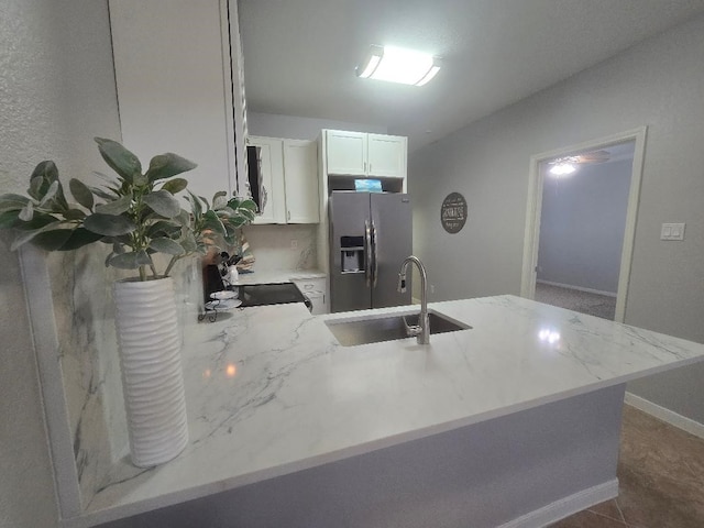 176 Capetown, Conroe, TX 77356 - kitchen featuring stainless steel fridge with ice dispenser, a peninsula, white cabinets, and light stone countertops