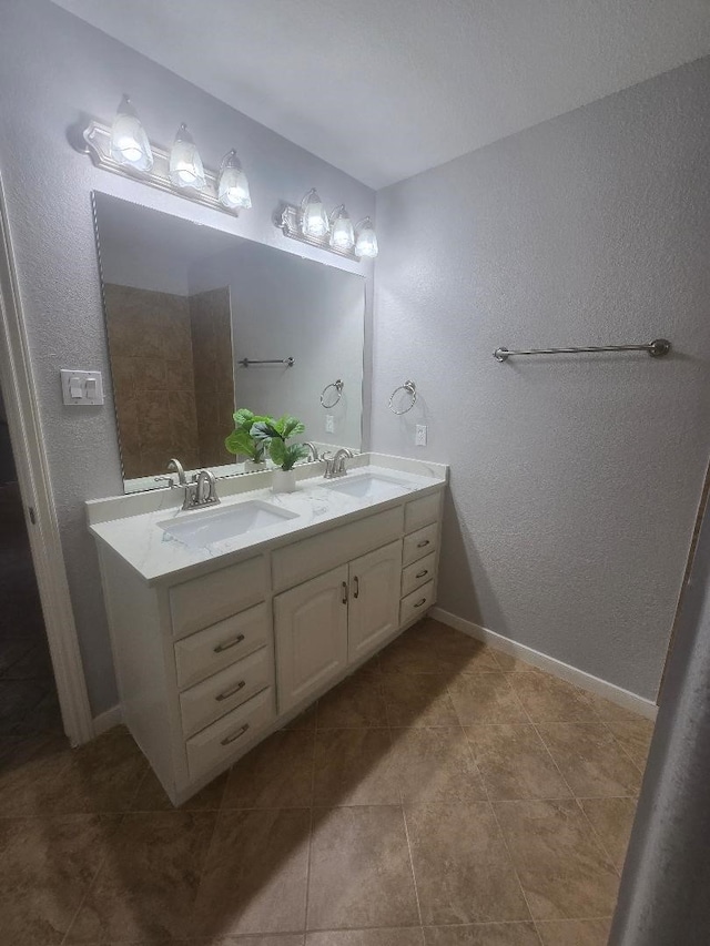 176 Capetown, Conroe, TX 77356 - bathroom with double vanity, a textured wall, and tile patterned floors