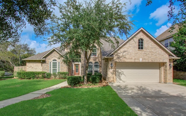 2512 Eagle Post Dr, Conroe, TX 77304 - traditional home featuring concrete driveway, a front lawn, brick siding, and roof with shingles