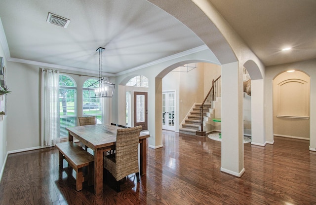 2512 Eagle Post Dr, Conroe, TX 77304 - dining space with wood finished floors, crown molding, arched walkways, recessed lighting, and stairs