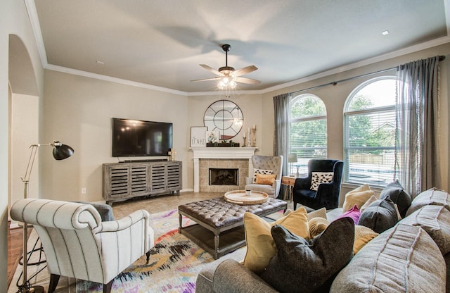 2512 Eagle Post Dr, Conroe, TX 77304 - living room with ceiling fan, a tile fireplace, crown molding, and arched walkways