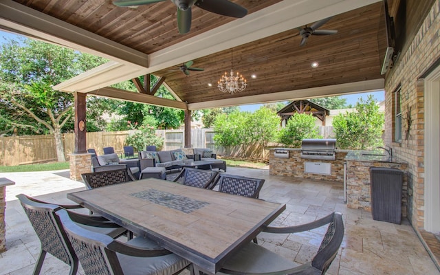 2512 Eagle Post Dr, Conroe, TX 77304 - fenced backyard with exterior kitchen, ceiling fan, outdoor dining space, and a patio area