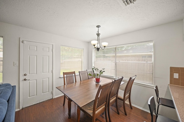 411 Pickford Dr, Katy, TX 77450 - dining space featuring dark wood-type flooring, a chandelier, and a textured ceiling