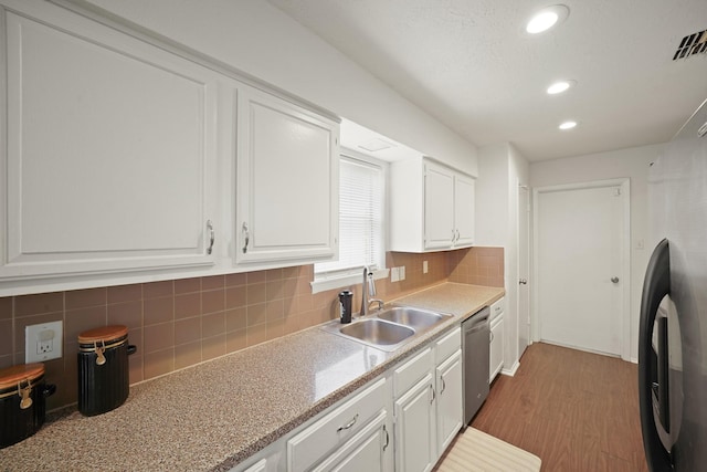 411 Pickford Dr, Katy, TX 77450 - kitchen with stainless steel dishwasher, freestanding refrigerator, white cabinetry, wood finished floors, and tasteful backsplash